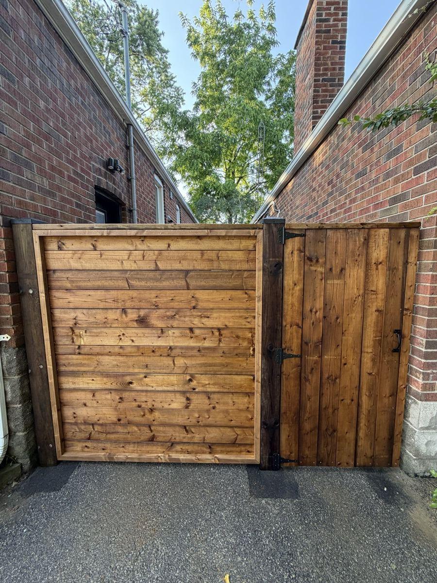 A custom wood gate and privacy fence built by HB Landscaping